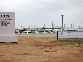 FILE - In this June 30, 2015, file photo, signs are seen at the entrance to the South Texas Family Residential Center in Dilley, Texas. The 2,400-bed detention facility that the Trump administration is using to detain immigrant mothers and children will now operate under an arrangement the U.S. government quietly reached with a private prison operator and the city where it's located. The Associated Press obtained contracts that show U.S. Immigration and Customs Enforcement will maintain largely the same structure that government auditors criticized earlier this year.