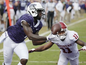 TCU wide receiver Jalen Reagor (1) catches a pass in the end zone for a touchdown as Oklahoma cornerback Parnell Motley (11) defends during the first half of an NCAA college football game, Saturday, Oct. 20, 2018, in Fort Worth, Texas.