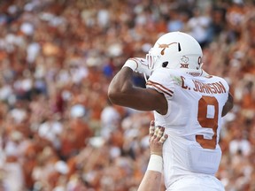 Texas wide receiver Collin Johnson (9) celebrates after scoring a touchdown on a 2-yard reception against Oklahoma during the first half of an NCAA college football game at the Cotton Bowl, Saturday, Oct. 6, 2018, in Dallas.