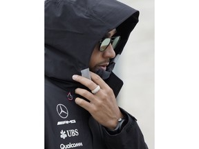 Mercedes driver Lewis Hamilton, of Britain, walks to a news conference for the Formula One U.S. Grand Prix auto race at the Circuit of the Americas, Thursday, Oct. 18, 2018, in Austin, Texas.