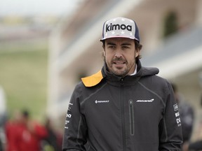 McLaren driver Fernando Alonso, of Spain, arrives for a news conference for the Formula One U.S. Grand Prix auto race at the Circuit of the Americas, Thursday, Oct. 18, 2018, in Austin, Texas.