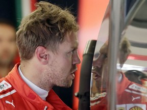 Ferrari driver Sebastian Vettel, of Germany, talks with his crew following the first practice session for the Formula One U.S. Grand Prix auto race at the Circuit of the Americas, Friday, Oct. 19, 2018, in Austin, Texas.