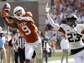 Texas wide receiver Collin Johnson (9) makes a catch in front of Baylor cornerback Derrek Thomas (23) for a 44-yard touchdown during the first half of an NCAA college football game, Saturday, Oct. 13, 2018, in Austin, Texas.