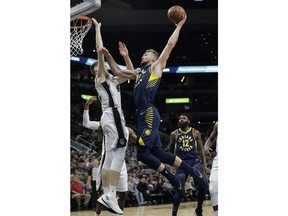Indiana Pacers forward Domantas Sabonis (11) drives to the basket over San Antonio Spurs forward Davis Bertans (42) during the first half of an NBA basketball game, Wednesday, Oct. 24, 2018, in San Antonio.