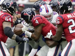 Houston Texans quarterback Deshaun Watson (4) is hit by Buffalo Bills defensive tackle Kyle Williams (95) during the first quarter of an NFL football game, Sunday, Oct. 14, 2018, in Houston.