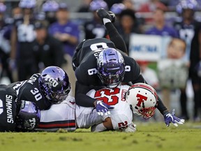 Texas Tech's Seth Collins (22) is tackled by TCU's Innis Gaines (6) during the first half of an NCAA college football game Thursday, Oct. 11, 2018, in Fort Worth, Texas.
