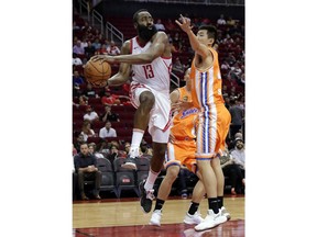 Houston Rockets guard James Harden (13) passes the ball around Shanghai Sharks guard Shi Yuchen (47) during the second half of an exhibition NBA basketball game Tuesday, Oct. 9, 2018, in Houston.