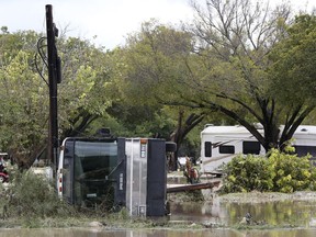 Recreation vehicles are seen strewn about at the South Llano River RV Park and Resort in Junction, Texas, Monday, Oct. 8, 2018. Heavy rains the area caused the Llano River to flood and about 19 people were rescued. One woman swept away by floodwaters drifted approximately 25 miles before she was rescued, according to the Texas A&M Forest Service.