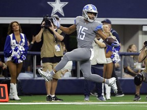 Detroit Lions wide receiver Golden Tate looks over his shoulder on a touchdown run on a pass from Matthew Stafford in the first half of an NFL football game against the Dallas Cowboys in Arlington, Texas, Sunday, Sept. 30, 2018.