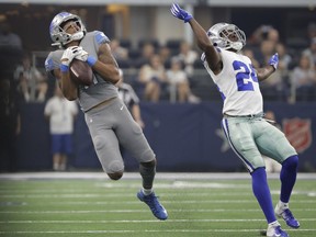 Detroit Lions wide receiver Marvin Jones (11) catches a pass in front of Dallas Cowboys cornerback Chidobe Awuzie (24) in the first half of an NFL football game in Arlington, Texas, Sunday, Sept. 30, 2018.