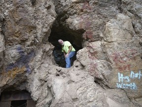 In this Aug. 11, 2018, photo, Bill Powell travels in to a mine near Eureka, Utah. He searched similar mines for months before his 18-year-old son Riley and girlfriend Brelynne Otteson were found dead in a shaft in March. During the search, he formed friendships with mine explorers who volunteered to help. Despite his painful memories, Powell decided to see what draws them there.