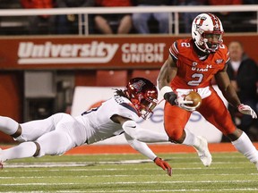 Utah running back Zack Moss (2) eludes Arizona safety Demetrius Flannigan-Fowles (6) during the first half during an NCAA college football game Friday, Oct. 12, 2018, in Salt Lake City.