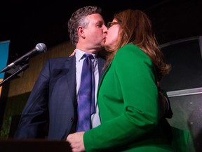 Vancouver mayor-elect Kennedy Stewart, left, kisses his wife Dr. Jeanette Ashe after addressing supporters in Vancouver on Sunday, Oct. 21, 2018.