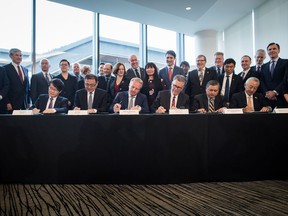 Seated from left to right, Inkee Kim, of KOGAS, Wei Gao, of PetroChina, Maarten Wetselaar, of Shell, LNG Canada CEO Andy Calitz, Adnan Zainal Abidin, of PETRONAS, and Hidenori Takaoka, of Mitsubishi Corporation, sign a final investment declaration to build the LNG Canada export facility in Kitimat, during a news conference in Vancouver on Tuesday, Oct. 2, 2018.