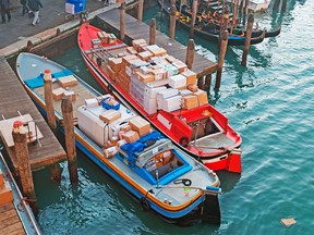 Courier boats full of parcels in Venice.