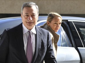 European Central Bank President Mario Draghi, left, arrives for a meeting of eurogroup finance ministers at the European Council building in Luxembourg, Monday, Oct. 1, 2018.
