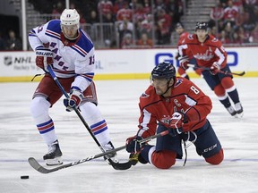 Washington Capitals left wing Alex Ovechkin (8), of Russia, battles for the puck against New York Rangers center Kevin Hayes (13) during the first period of an NHL hockey game, Wednesday, Oct. 17, 2018, in Washington.