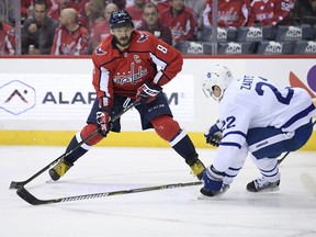 Washington Capitals left wing Alex Ovechkin (8), of Russia, skates with the puck against Toronto Maple Leafs defenseman Nikita Zaitsev (22), of Russia, during the second period of an NHL hockey game, Saturday, Oct. 13, 2018, in Washington.