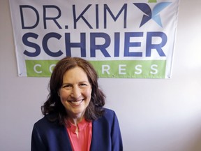 FILE - In this March 30, 2018, file photo, Dr. Kim Schrier, a candidate in Washington state's 8th District race, poses for a photo in Issaquah, Wash. Schrier, a Democratic, is running against Republican Dino Rossi in an open and true toss-up race for the seat to succeed retiring incumbent, Rep. Dave Reichert. The district includes the eastern suburbs of Seattle and stretches into the rural Cascade Mountain region.