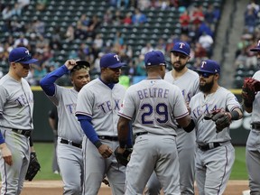 Texas Rangers' Adrian Beltre (29), is greeted by teammates before walking off the field during the fifth inning of a baseball game against the Seattle Mariners after he was replaced by Jurickson Profar at third base, Sunday, Sept. 30, 2018, in Seattle.