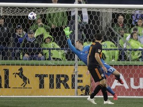 Houston Dynamo goalkeeper Joe Willis reaches for but cannot get to a goal kicked by Seattle Sounders forward Will Bruin (not shown) as Dynamo's Andrew Wenger looks on during the first half of an MLS soccer match Monday, Oct. 8, 2018, in Seattle.