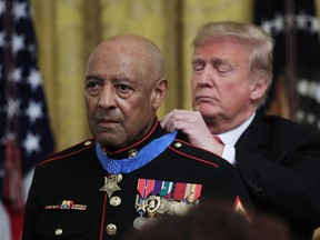 President Donald Trump presents the Medal of Honor to U.S. Marine Corps retired Sgt. Maj. John Canley, during an East Room ceremony at the White House in Washington, Wednesday, Oct. 17, 2018. Canley is the 300th Marine to receive the nation's highest military medal.