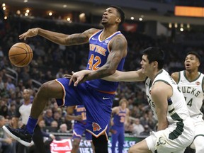 New York Knicks' Lance Thomas (42) is fouled by Milwaukee Bucks' Ersan Ilyasova during the first half of an NBA basketball game Monday, Oct. 22, 2018, in Milwaukee.