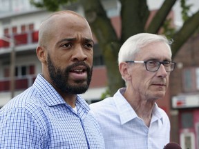 FILE - In this Aug. 15, 2018, file photo, Wisconsin Democratic lieutenant governor candidate Mandela Barnes, left, and governor candidate Tony Evers speak to reporters at a news conference in Madison, Wis. Barnes said Tuesday, Oct. 16, 2018, that a lingerie party he threw nearly a decade ago was "immature," and that he is committed to "gender equality, including closing the pay gap, expanding paid family leave, and protecting the rights of women to make their own health care decisions." Wisconsin Republicans, who pointed out the invitation still visible on Facebook, called on Evers to condemn it.