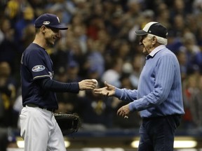 Bob Uecker throws out the ceremonial first pitch before Game 1 of the National League Championship Series baseball game between the Milwaukee Brewers and the Los Angeles Dodgers Friday, Oct. 12, 2018, in Milwaukee.