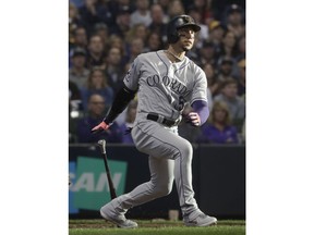 Colorado Rockies' Carlos Gonzalez hits a triple during the fifth inning of Game 1 of the National League Divisional Series baseball game against the Milwaukee Brewers Thursday, Oct. 4, 2018, in Milwaukee.