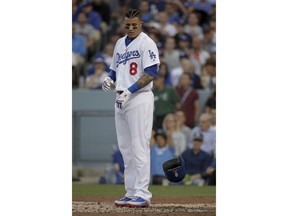 Los Angeles Dodgers' Manny Machado throws his helmet after striking out against the Boston Red Sox during the first inning in Game 5 of the World Series baseball game on Sunday, Oct. 28, 2018, in Los Angeles.