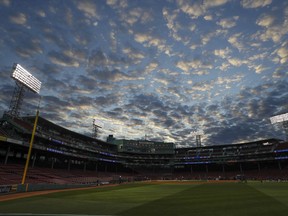 Clouds fill the sky over Fenway Park as the Los Angeles Dodgers practice for Game 1 of the World Series baseball game against the Boston Red Sox Monday, Oct. 22, 2018, in Boston.