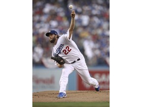 Los Angeles Dodgers starting pitcher Clayton Kershaw throws against the Boston Red Sox during the first inning in Game 5 of the World Series baseball game on Sunday, Oct. 28, 2018, in Los Angeles.