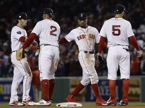 Boston Red Sox players celebrate after Game 1 of the World Series baseball game against the Los Angeles Dodgers Tuesday, Oct. 23, 2018, in Boston. The Red Sox won 8-4 to take a 1-0 lead in the series.