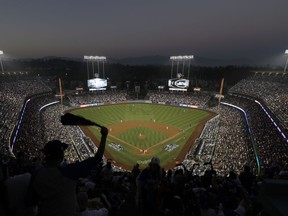 Fans cheer from the top of Dodger Stadium during Game 4 of the World Series baseball game between the Boston Red Sox and Los Angeles Dodgers on Saturday, Oct. 27, 2018, in Los Angeles.
