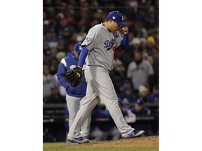 Los Angeles Dodgers pitcher Hyun-Jin Ryu walks back to the mound after walking Boston Red Sox's Andrew Benintendi to load the bases during the fifth inning of Game 2 of the World Series baseball game Wednesday, Oct. 24, 2018, in Boston.
