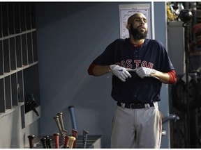 Boston Red Sox pitcher David Price takes his gloves off after batting during the second inning in Game 5 of the World Series baseball game on Sunday, Oct. 28, 2018, in Los Angeles.