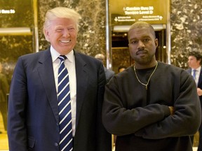 FILE - In this Dec. 13, 2016, file photo, President-elect Donald Trump and Kanye West pose for a picture in the lobby of Trump Tower in New York.  Kanye West will visit the White House on Thursday to meet with President Donald Trump and his son-in-law Jared Kushner talk about manufacturing in America, gang violence, prison reform and Chicago violence.