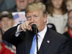 In this Oct. 26, 2018 photo, President Donald Trump points to the media as he speaks during a campaign rally in Charlotte, N.C. Trump is accusing the media of being "the true Enemy of People" in the wake of a mass shooting and a mail bomb plot.