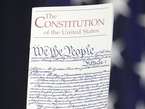 FILE - In this March 23, 2016 photo, the Constitution is held by a member of Congress on Capitol Hill in Washington. President Donald Trump says he wants to order the end of the constitutional right to citizenship for babies of non-citizens and unauthorized immigrants born in the United States.