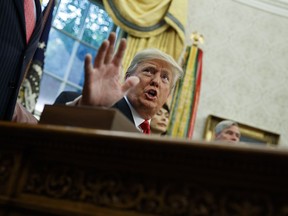 FILE - In this Oct. 11, 2018, file photo President Donald Trump talks with reporters in the Oval Office of the White House, in Washington. The disappearance of U.S. resident Jamal Khashoggi after visiting a Saudi consulate in Turkey has thrust the Trump administration's large number of diplomatic vacancies back into the spotlight.