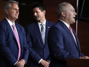 In this Sept. 13, 2018 file photo, House Speaker Paul Ryan of Wis., centre, talks with House Majority Leader Kevin McCarthy of Calif., left, while House Majority Whip Steve Scalise, R-La., speaks during a news conference in Washington.