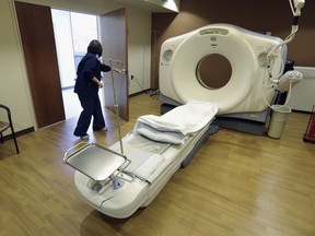 FILE - In this Jan. 9, 2013, file photo, a CT scan technician prepares for a patient at the Silver Cross Emergency Care Center in Homer Glen, Ill. The Trump administration is quietly trying to weaken radiation rules, relying on scientific outliers who argue that a little radiation damage is actually good for you _ like a little bit of sunlight.