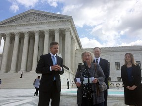 Pennsylvania resident Rose Mary Knick speaks outside the Supreme Court, Wednesday, Oct. 3, 2018 in Washington, alongside her attorneys J. David Breemer, left, Brian Hodges and Christina Martin. Knick is at the center of a case the Supreme Court is hearing that stems from her dispute with her town over an ordinance that says landowners who have cemeteries on their properties must make them open to the public during daylight hours.