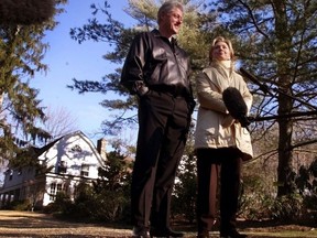 FILE - In this Jan. 6, 2000 file photo, Bill and Hillary Clinton stand in the driveway of their new home in Chappaqua, N.Y. A U.S. official says a "functional explosive device" was found at Hillary and Bill Clinton's suburban New York home. (AP Photo, File)
