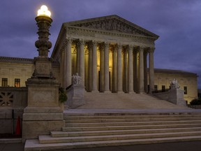 In this Oct. 5, 2018 photo the U. S. Supreme Court building stands quietly before dawn in Washington.  A couple of liberal Harvard law professors are lending their name to a new campaign that wants to build support for expanding the Supreme Court by four justices. The campaign being launched Wednesday also wants to increase the size of the lower federal courts to counteract what it terms "Republican obstruction, theft and procedural abuse" of the federal judiciary.