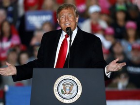 In this Oct. 27, 2018, photo, President Donald Trump speaks during a rally at Southern Illinois Airport in Murphysboro, Ill. Eager to focus voters on immigration in the lead-up to the midterm elections, Trump on Oct. 29 escalated his threats against a migrant caravan trudging slowly toward the U.S. border as the Pentagon prepared to deploy thousands of U.S. troops to support the border patrol.