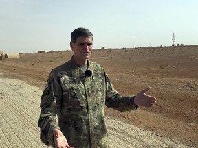 US Gen. Joseph Votel, top U.S. commander in the Middle East, speaks to reporters during an unannounced visit Monday, Oct. 22, 2018, to the al-Tanf military outpost in southern Syria. The U.S. trains Syrian opposition forces at the outpost.