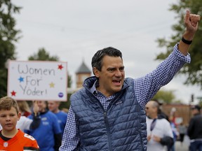 In this Sept. 29, 2018, photo, Rep. Kevin Yoder, R-Kan., waves to the crowd during the Overland Park fall festival parade in Overland Park, Kan. The National Republican Congressional Committee is dropping its support for a congressman facing a difficult re-election in a suburban Kansas City district won by Hillary Clinton.