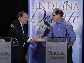 In this Oct. 8, 2018 photo, Sen. Joe Donnelly, D-Ind., left, shakes hands with Republican former state Rep. Mike Braun following a U.S. Senate Debate in Westville, Ind. Libertarian Lucy Brenton also participated in the debate.